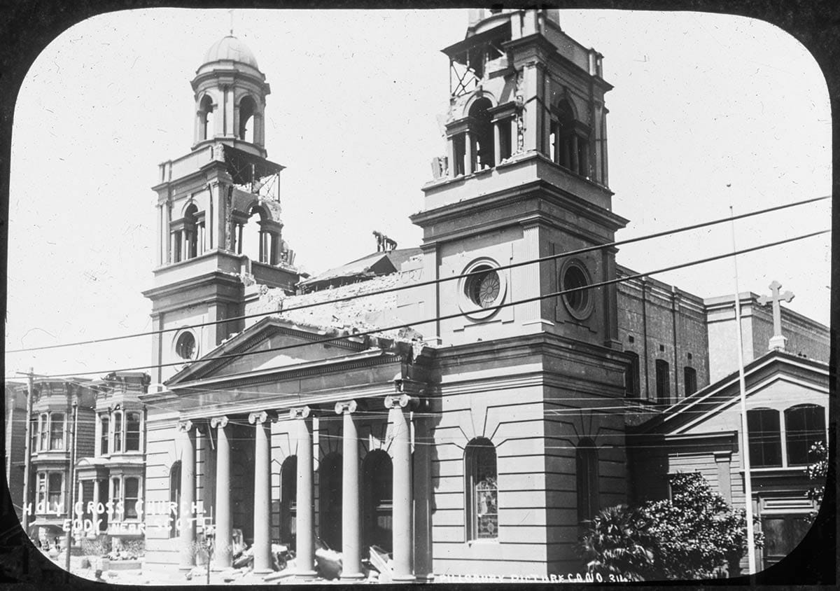 earthquake-damaged church with old parish hall beside